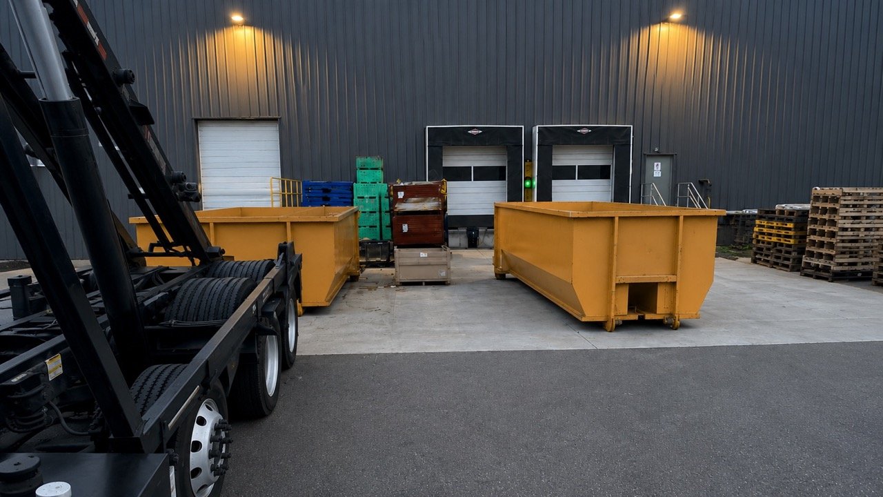 Commercial roll-off dumpsters at Detroit warehouse loading dock